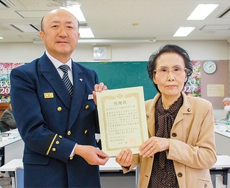 表彰状を持つ関会長（右）と木村署長