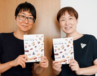 記念誌を持つ森本さん(左)と井上事務局長