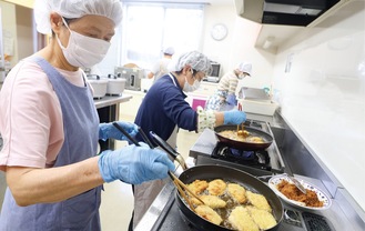 弁当の調理を行うメンバーたち