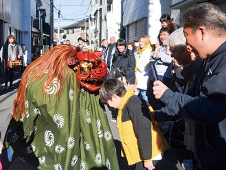 獅子が住民一人ひとりの頭を噛み、厄を払った