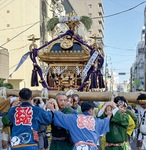 貝塚を練り歩く担ぎ手▶