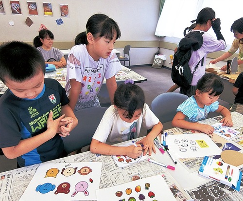 蜜蝋ラップ作りをする子どもたち