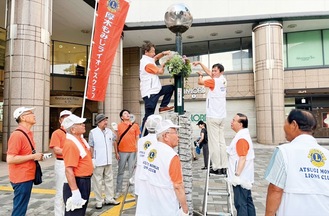 花を飾るメンバーら