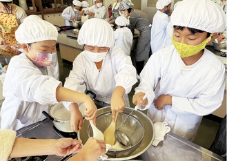 みんなで協力しながら豆腐づくりに挑戦＝11月28日・同校