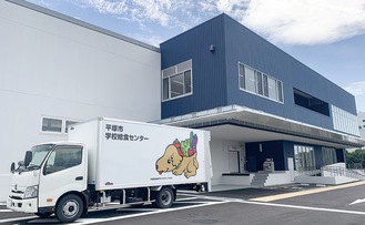 完成した給食センター。平塚農産物PRキャラクター「ベジ太」が描かれたトラックが給食を届ける