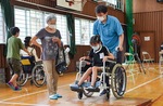 車イスの乗車体験をする小学生と家族