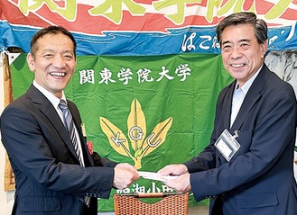 昇格祝、奨励金を手渡す奥山支部長（右）と高橋教授