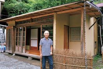 自身が造った茶室の前に立つ山田さん